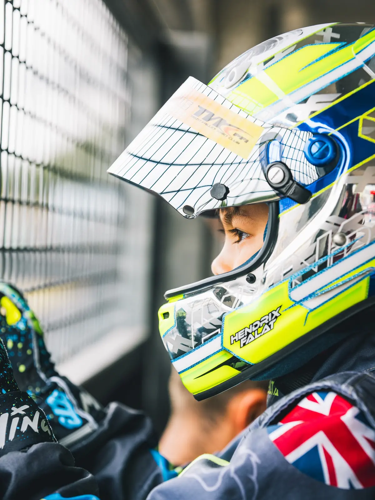 Hendrix Falat waiting on the grid, visor up, his name on the chin of the helmet