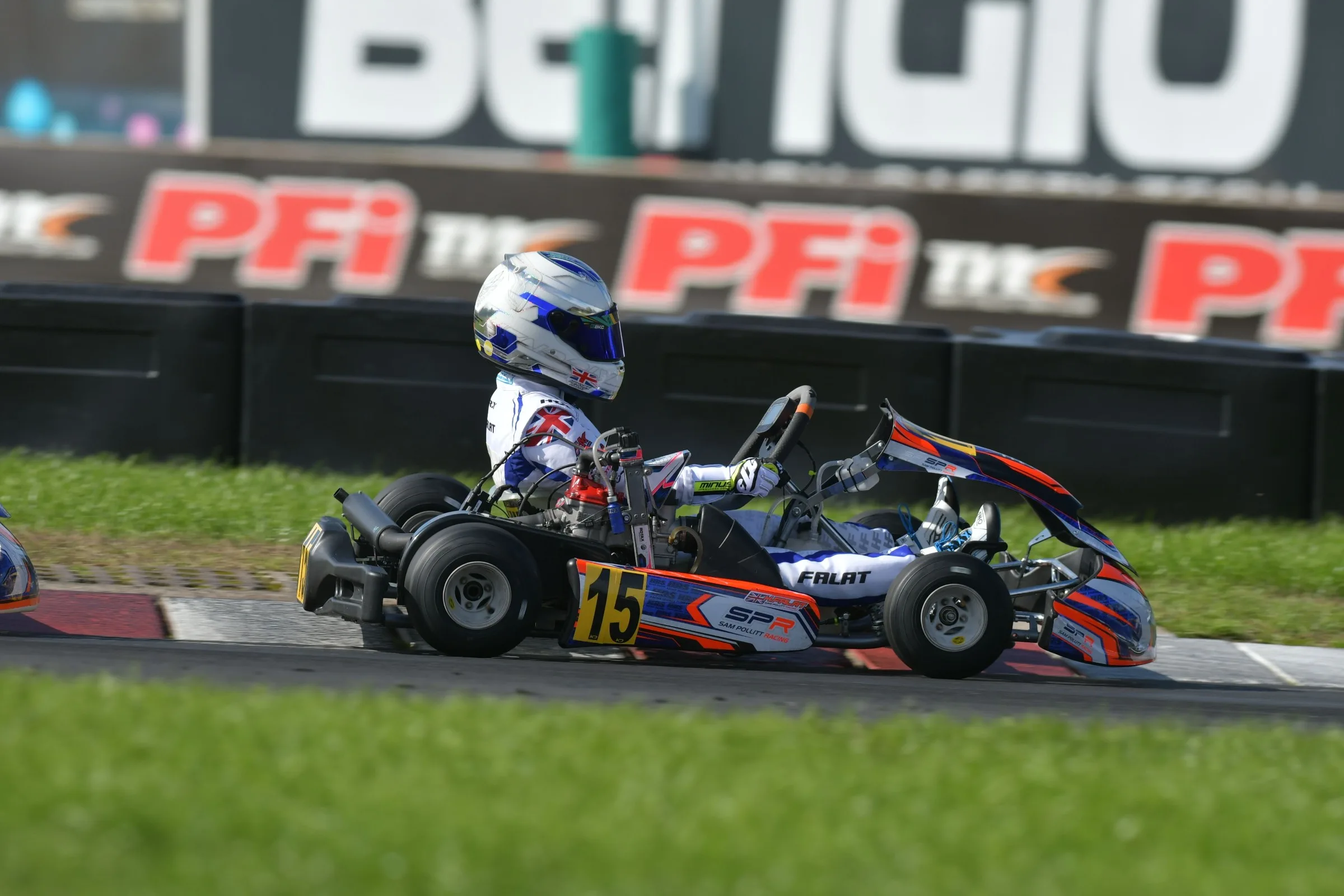 Hendrix Falat side by side with a rival kart on the pit straight